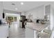 Beautiful, fully equipped kitchen with white cabinets, granite countertops, stainless appliances, and an open view to the dining area at 3857 Woodrow Ridge St, Sarasota, FL 34233