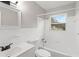 A clean bathroom featuring white tiling, a shower-tub combination, and modern fixtures at 4111 Rockefeller Ave, Sarasota, FL 34231