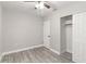 Bright bedroom with neutral walls, laminate flooring, a ceiling fan, and closet with sliding doors at 4111 Rockefeller Ave, Sarasota, FL 34231
