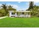 Charming single-story home with well-manicured lawn and a cozy front porch at 4111 Rockefeller Ave, Sarasota, FL 34231