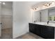 Modern bathroom featuring double vanity, sleek fixtures, and a large mirror over a contemporary design at 4240 Pond Brook Ct, Bradenton, FL 34211