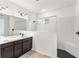 Bathroom featuring double vanity, modern fixtures, and tiled shower with bench seat at 4240 Pond Brook Ct, Bradenton, FL 34211