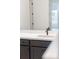 Close up of bathroom vanity with neutral countertop, dark cabinets and modern faucet at 4240 Pond Brook Ct, Bradenton, FL 34211