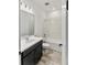 Bathroom featuring a vanity with dark wood cabinets and a shower-tub combination at 4240 Pond Brook Ct, Bradenton, FL 34211