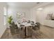 Elegant dining room with marble-look table that seats six, with modern decor and natural light at 4240 Pond Brook Ct, Bradenton, FL 34211