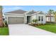 Charming single-story home with a well-manicured lawn, landscaped garden beds, and neutral-colored exterior at 4240 Pond Brook Ct, Bradenton, FL 34211