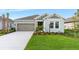 Beautiful single-story home with a well-kept lawn, palm trees, and a two-car garage offering great curb appeal at 4240 Pond Brook Ct, Bradenton, FL 34211