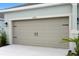 A close-up shot of the garage door, highlighting the hardware and panel design details at 4240 Pond Brook Ct, Bradenton, FL 34211