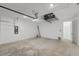Spacious two car garage with white painted walls and concrete floor perfect for storage and cars at 4240 Pond Brook Ct, Bradenton, FL 34211