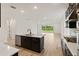 Modern kitchen features an island, stainless steel appliances, and easy access to the living area and backyard at 4240 Pond Brook Ct, Bradenton, FL 34211