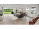 Living room features modern decor, a cozy seating area, and sliding glass doors with backyard views at 4240 Pond Brook Ct, Bradenton, FL 34211