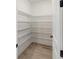 Walk-in pantry with ample shelving to maximize storage, next to the kitchen at 4240 Pond Brook Ct, Bradenton, FL 34211