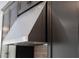 Close-up of a stainless steel range hood, providing ventilation above the stovetop in the modern kitchen at 4240 Pond Brook Ct, Bradenton, FL 34211