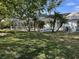 Spacious backyard featuring a screened-in pool area with palm trees and well-maintained green grass at 4538 Hamlets Grove Dr, Sarasota, FL 34235