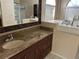 Bathroom features a walk-in tub, granite countertop vanity, a glass shower, and a large mirror at 4538 Hamlets Grove Dr, Sarasota, FL 34235