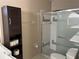 Bathroom features a glass shower, toilet, and dark cabinet with storage at 4538 Hamlets Grove Dr, Sarasota, FL 34235
