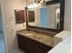 Bathroom shows a granite countertop vanity, a large mirror, updated cabinets, and fixtures at 4538 Hamlets Grove Dr, Sarasota, FL 34235
