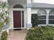 Close-up of front door and manicured landscape. Notice the column details and window features at 4538 Hamlets Grove Dr, Sarasota, FL 34235