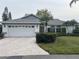 Single-story home with a brick driveway, two-car garage and well-maintained landscaping at 4538 Hamlets Grove Dr, Sarasota, FL 34235