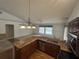 Kitchen features granite countertops and stainless steel appliances, open to the living area at 4538 Hamlets Grove Dr, Sarasota, FL 34235