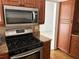 Updated kitchen features stainless steel appliances and stylish granite countertops at 4538 Hamlets Grove Dr, Sarasota, FL 34235