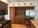 Kitchen features wooden cabinets, granite countertops, and stainless steel appliances at 4538 Hamlets Grove Dr, Sarasota, FL 34235