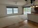 Spacious living room adjacent to kitchen with natural light at 4538 Hamlets Grove Dr, Sarasota, FL 34235