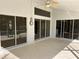 Covered patio with ceiling fan, multiple sliding glass doors provide seamless indoor-outdoor flow and natural light at 4538 Hamlets Grove Dr, Sarasota, FL 34235