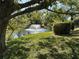 Beautiful pond with a fountain surrounded by green grass and trees creating a serene view at 4538 Hamlets Grove Dr, Sarasota, FL 34235