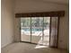 Sliding glass doors off bedroom lead to the screened in pool area at 4538 Hamlets Grove Dr, Sarasota, FL 34235