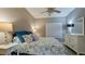 Comfortable bedroom with a ceiling fan, dresser, and decorative nautical themed bedding and pillows at 4802 51St W St # 319, Bradenton, FL 34210