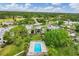Aerial view of community featuring lush landscaping, residential buildings, and a refreshing community pool on a sunny day at 5042 Marsh Field Rd # 16, Sarasota, FL 34235