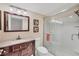 Updated bathroom with granite countertop and walk-in shower with glass doors at 5042 Marsh Field Rd # 16, Sarasota, FL 34235