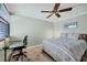 A cozy bedroom featuring a workspace with an office chair and a spacious desk at 5042 Marsh Field Rd # 16, Sarasota, FL 34235