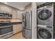Well-equipped kitchen with stainless steel appliances and adjacent laundry area at 5042 Marsh Field Rd # 16, Sarasota, FL 34235