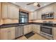 Bright kitchen with stainless steel appliances, speckled dark counters, and off white cabinets at 5042 Marsh Field Rd # 16, Sarasota, FL 34235