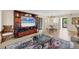Comfortable living area with hardwood floors, a decorative rug, and an entertainment center, adjacent to a dining space at 5042 Marsh Field Rd # 16, Sarasota, FL 34235