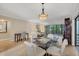 Open living area with view to lanai and dining area with adjacent desk at 5042 Marsh Field Rd # 16, Sarasota, FL 34235