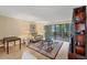 Bright living room boasts hardwood floors, a decorative rug, and sliding glass doors leading to a screened patio at 5042 Marsh Field Rd # 16, Sarasota, FL 34235