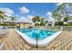 A sparkling community pool with clear blue water, surrounded by lounge chairs and well-maintained landscaping, creating a serene oasis at 5042 Marsh Field Rd # 16, Sarasota, FL 34235