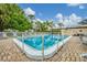 A sparkling community pool with lounge chairs, surrounded by lush greenery and offering a relaxing resort-style ambiance at 5042 Marsh Field Rd # 16, Sarasota, FL 34235