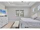 Bright main bedroom with neutral color palette, tray ceiling, and ensuite bathroom access at 5203 Title Row Dr, Bradenton, FL 34210