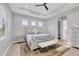 Comfortable bedroom featuring neutral tones, tray ceiling, and natural light at 5203 Title Row Dr, Bradenton, FL 34210