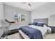 Bedroom featuring a gray bed, treadmill, dresser, and window with plantation shutters at 5203 Title Row Dr, Bradenton, FL 34210