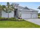 Charming gray home with a well-manicured lawn and lush landscaping at 5203 Title Row Dr, Bradenton, FL 34210