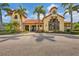 Community building with tile roof, columns, beautiful landscaping, and large windows at 5203 Title Row Dr, Bradenton, FL 34210