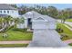 Beautiful one-story home featuring a three-car garage and manicured lawn with palm trees at 5203 Title Row Dr, Bradenton, FL 34210