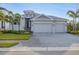Charming single-story home with a three-car garage and elegant front entrance and brick-paved driveway at 5203 Title Row Dr, Bradenton, FL 34210