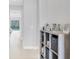 Long hallway leading to the pool area with decorative shelving and tiled floors at 5203 Title Row Dr, Bradenton, FL 34210