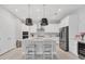 Bright, modern kitchen featuring stainless steel appliances, island seating, and pendant lights at 5203 Title Row Dr, Bradenton, FL 34210